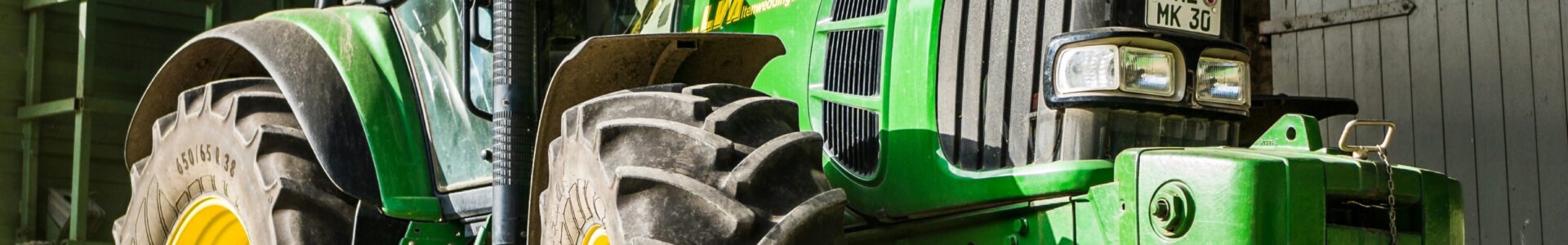 a green tractor used in agriculture
