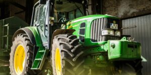 a green tractor used in agriculture