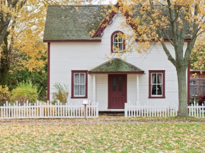 white house under maple trees