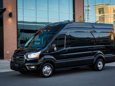 black modern ford transit on city road